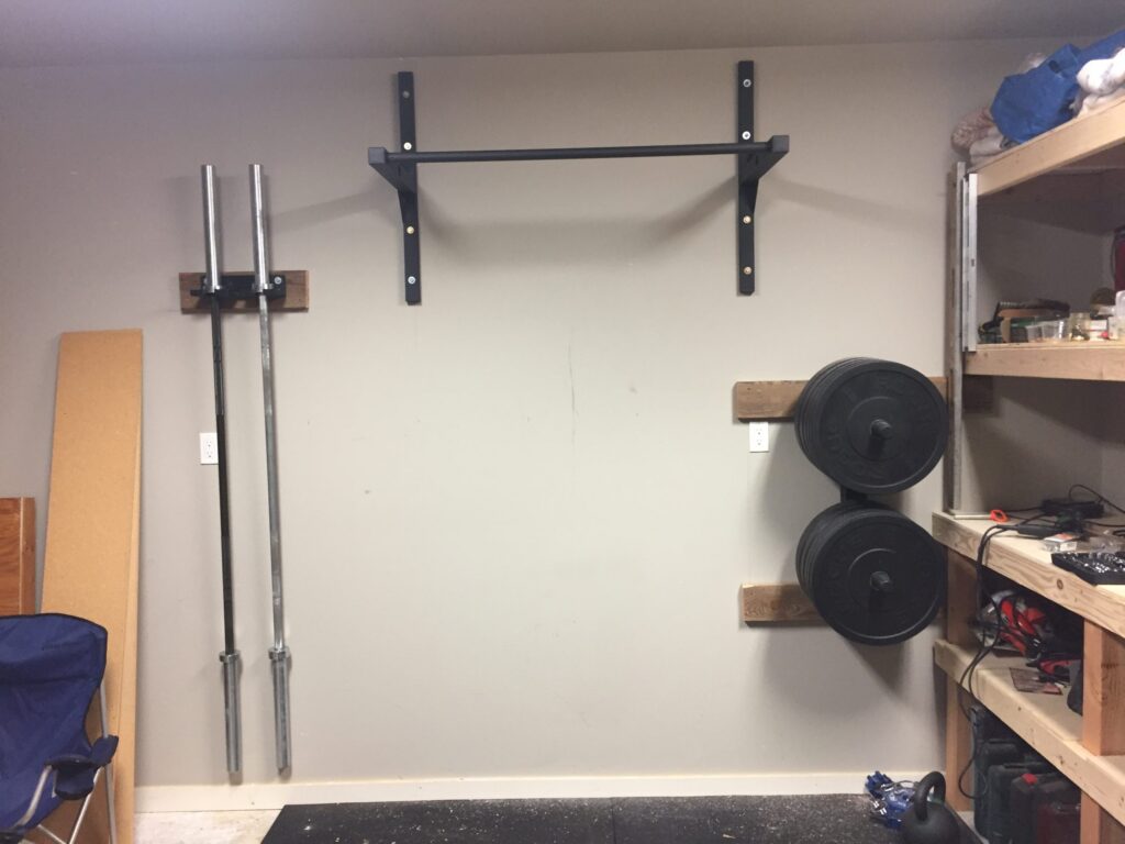 Wall mounted pull-up bar installed in a garage gym