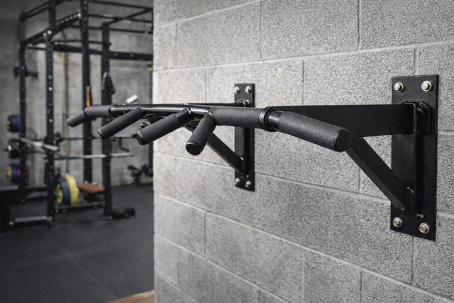 garage gym pull up bar setup showing wall mounted strength training equipment