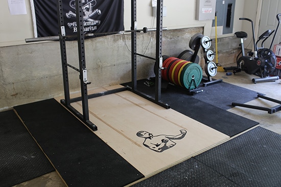 Home gym soundproofing setup with rubber flooring and deadlift platform in garage gym