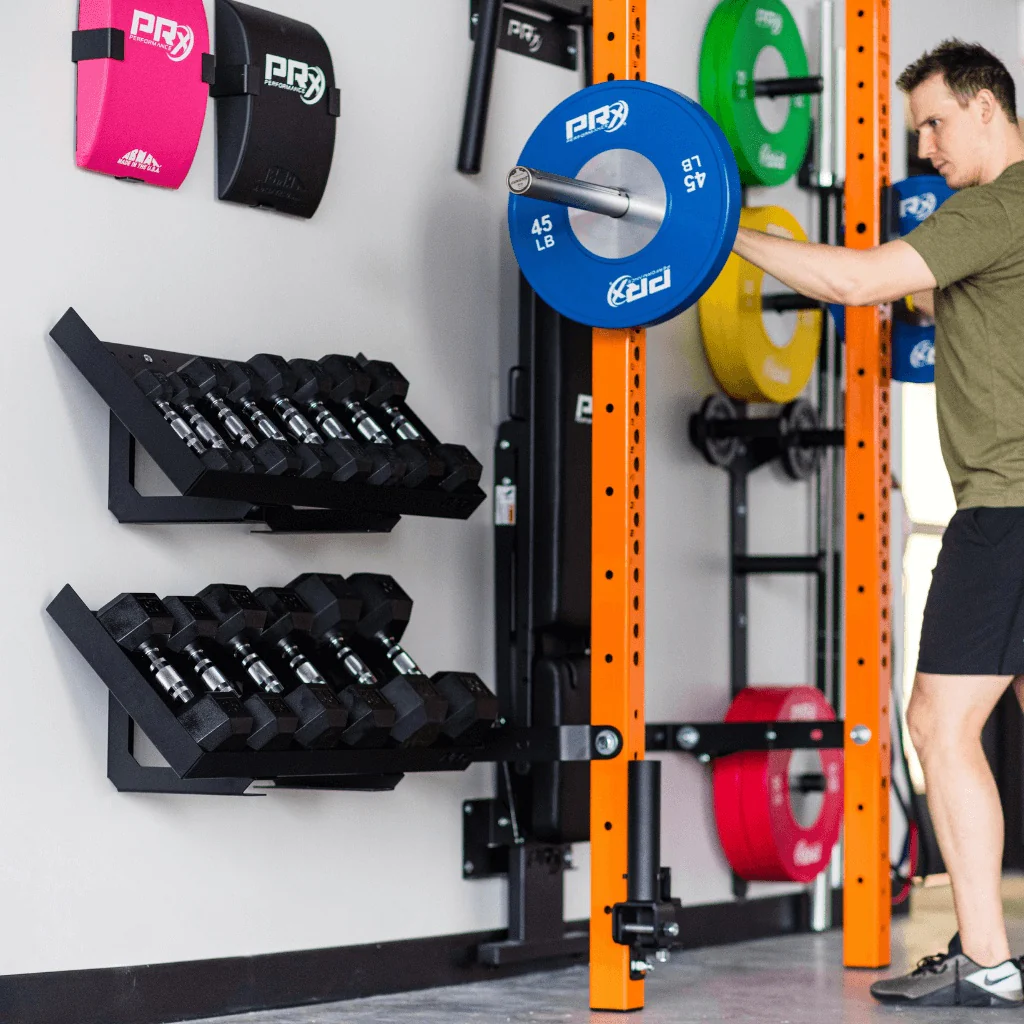 Garage gym wall storage with organized weight plates and dumbbells
