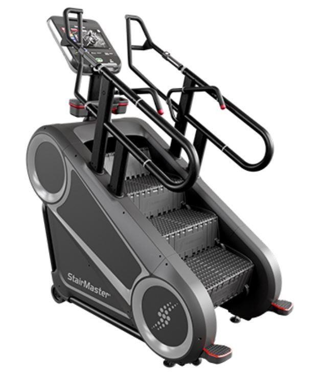 Close view of a commercial stair machine with rotating steps and sturdy handrails