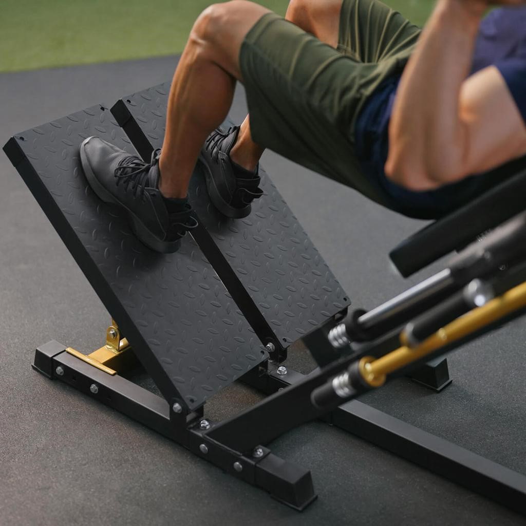 hack squat machine with weight plates for lower body training
